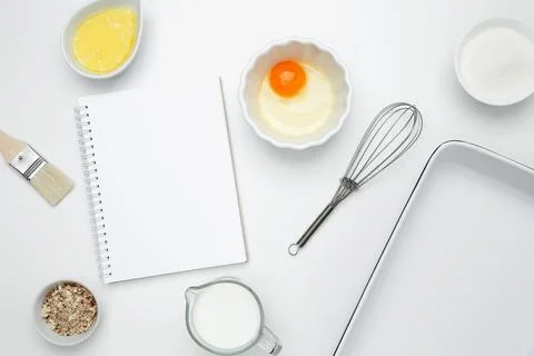 Open white notebook with baking ingredients for Crinkle Cake, including butte Stock Photos