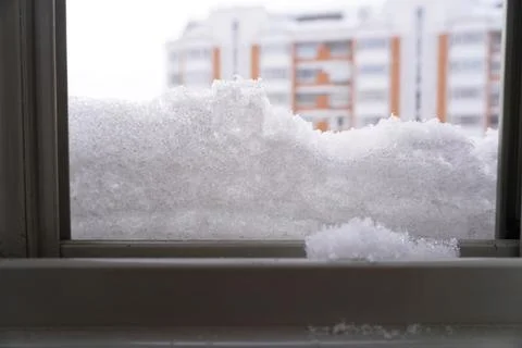 An open window, dusted with snow. Stock Photos