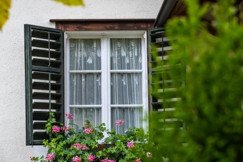 Open Window on the Facade of a white local traditional old House decorated wi Stock Photos