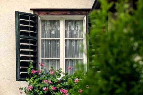 Open Window on the Facade of a white local traditional old House decorated wi Stock Photos