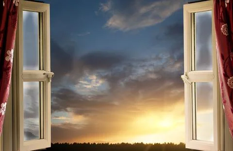 Open window looking out on to amazing sunset and clouds Stock Photos
