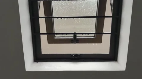 Open Window with Security Bars During Heavy Rain Stock Footage 344019601