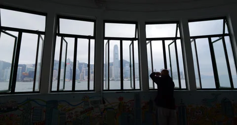 Open windows at ferry pier terminal, urban Hong Kong island seen through Stock Footage 309402016