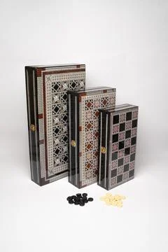 Open wooden backgammon set with playing pieces Stock Photos