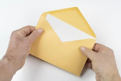 An open yellow envelope in the hands Foto stock