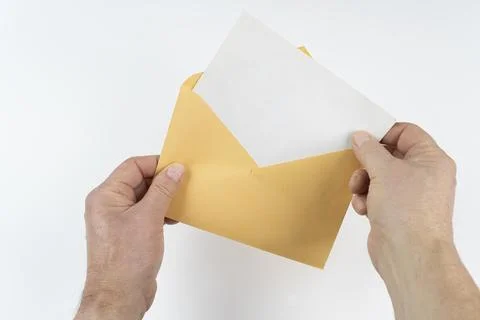 An open yellow envelope in the hands Foto stock