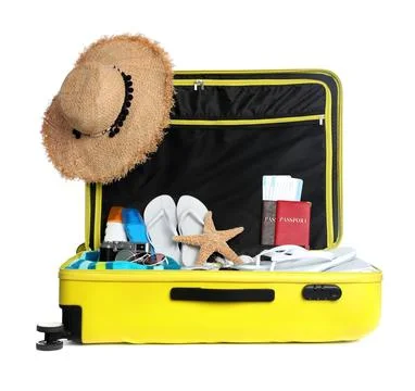 Open yellow suitcase with different beach objects on white background Fotos de archivo