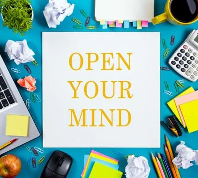 Open your mind. Office table desk with supplies, white blank note pad, cup, pen Stock-Fotos