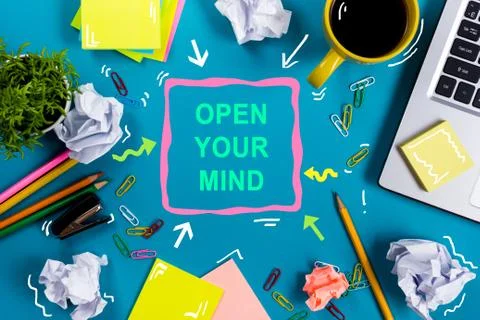 Open your mind. Office table desk with supplies, white blank note pad, cup, pen Stock Photos