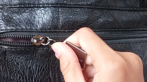 Open the zip of the black leather bag Stock Footage 150215155