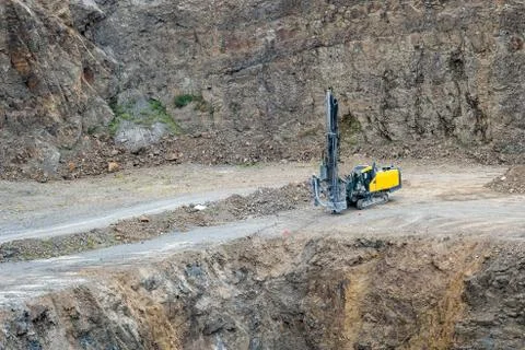 Opencast mining quarry with mining drilling machine. Mining in the granite qu Stock Photos