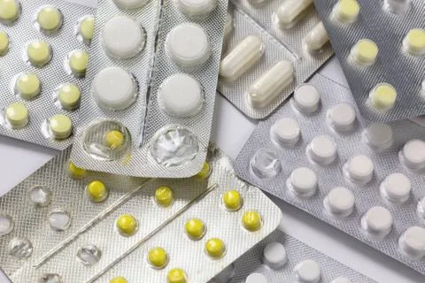 Opened and partially used tablets blister background Stockfoto's