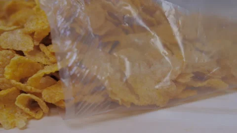 Opened bag of breakfast corn flakes cereals on kitchen table 4k Stock Footage 148315407