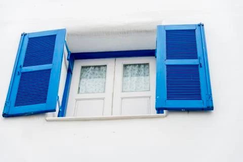 Opened blue window on white wall Stock Photos