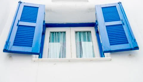 Opened blue window on white wall Stock Photos