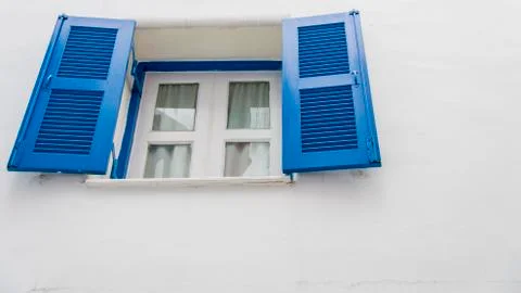 Opened blue window on white wall Stock Photos