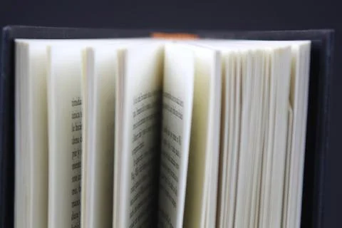 Opened book on black background Stock Photos