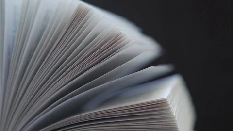 Opened book on a dark background isolated : leafing through books Stock-Footage 76705684