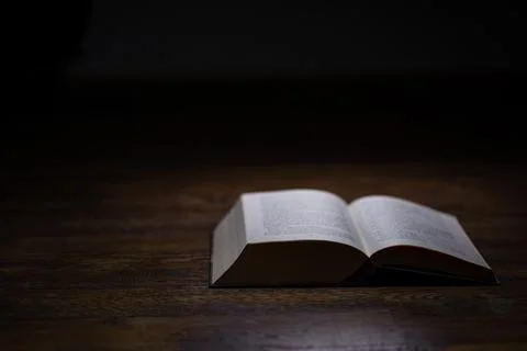 Opened book on dark background Stock Photos