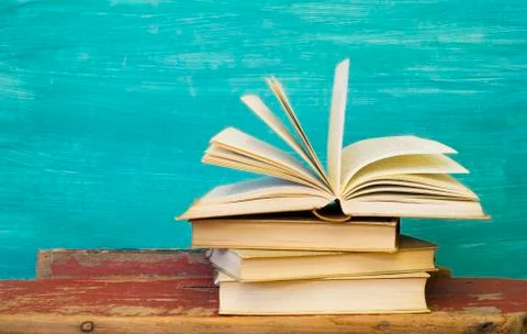 Opened book  on green background, reading, eduaction, literature,novel Stock Photos