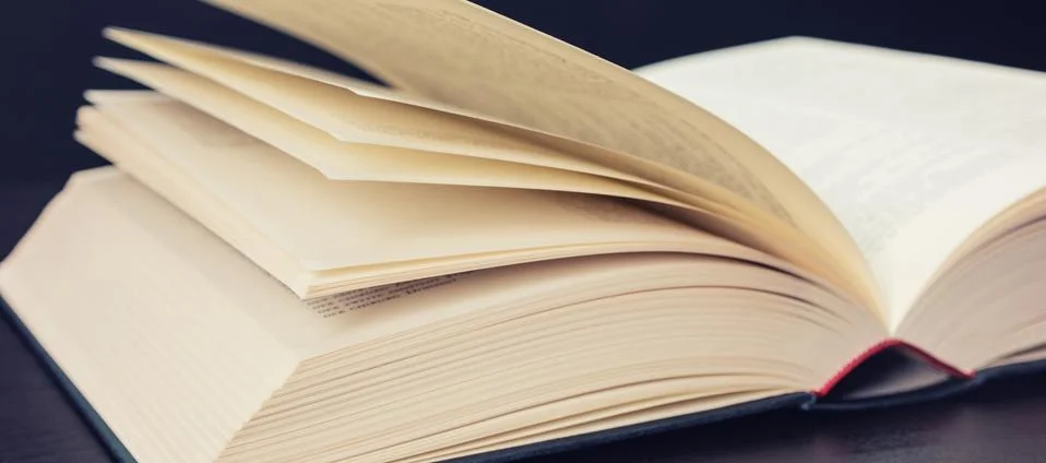 Opened book pages on a table Фото