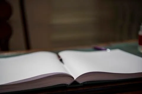 Opened book on the table. Close up. Stock Photos