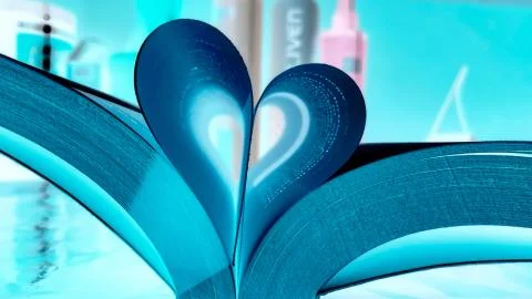 Opened book on the table with pages like heart Stock Photos