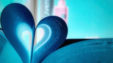 Opened book on the table with pages like heart Stock Photos