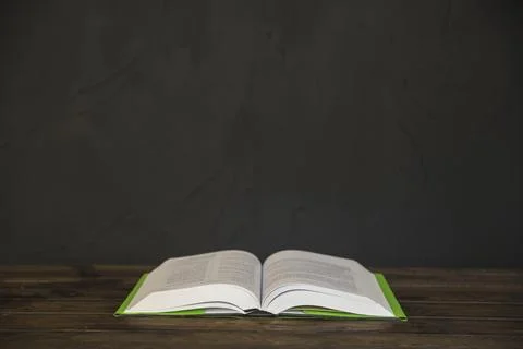 Opened book wooden table Stock Photos