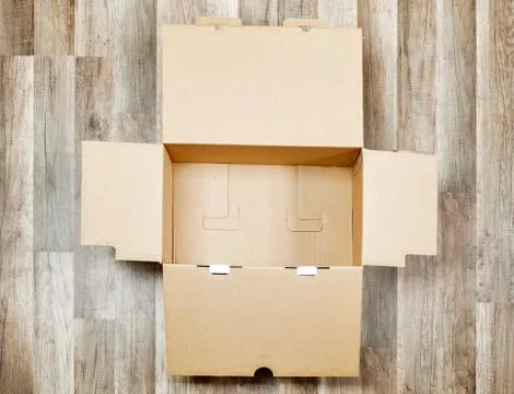 Opened box on the floor Stock Photos