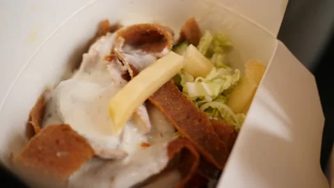 Opened boxes of food delivery in takeaway paper boxes a doner kebab meat dish Stock Footage 143639160