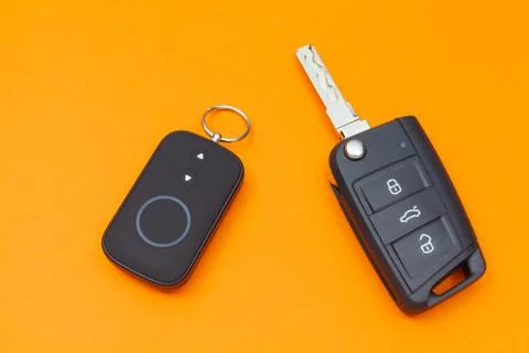 Opened Car Key with Remote Control on an orange background, top view Fotos Stock