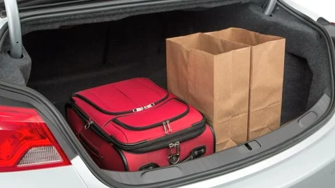 Opened car trunk with luggage Silver Ice Metallic 2017 Chevrolet Impala Premier Stock Footage 159901569