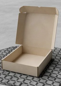 Opened Cardboard box on the table with a square tablecloth Ilustração Stock