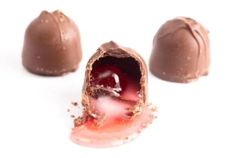 An Opened Chocolate Covered Cherry on a White Background Stock Photos