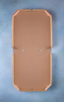 Opened clean pizza box on blue background Stock Photos