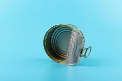 Opened clean tin can with pull tab ring, bended lid and empty - isolated on b Stock Photos