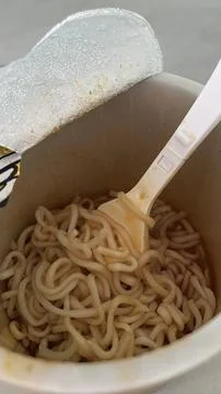 Opened Cup Noodles with Fork Twisting the Noodles Stock Photos