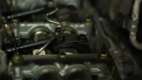 An opened cylinder head of an internal combustion engine exposes camshafts, a Stock Footage 345109467