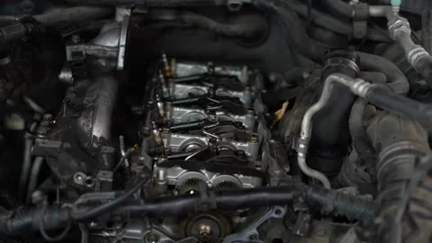 An opened cylinder head of an internal combustion engine exposes camshafts, a Stock Footage 345110357