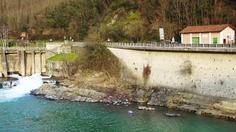 An opened dam on the Serchio river in Tuscany, Italy, 4K 스톡 동영상 75058632