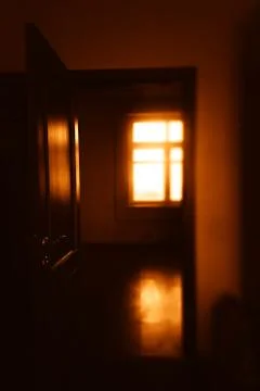 Opened door illuminated by dramatic sunset light backdrop Stock Photos
