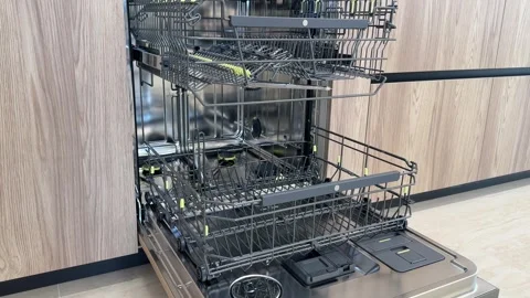 Opened empty clean dishwasher in kitchen Stock Footage 311560186
