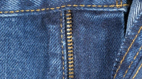 Opened fly on a pair of jeans, tracking. Close up top view. Slider shot Stock Footage 121342261