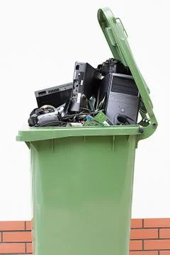 Opened garbage bin with electronics Stock Photos