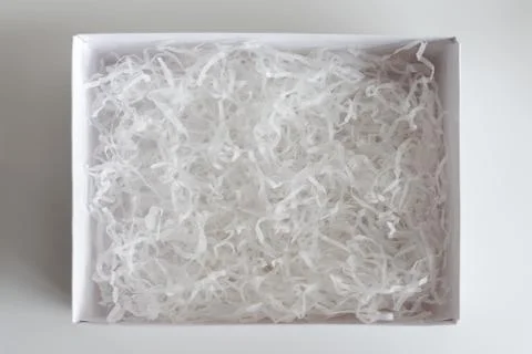 Opened gift box with decorative straw, filler, shavings. paper box for your p Stock Photos