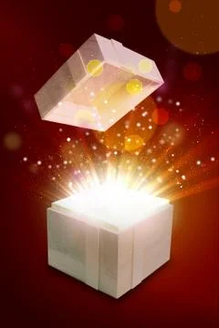 Opened gift box that emits a warm and bright light 写真素材