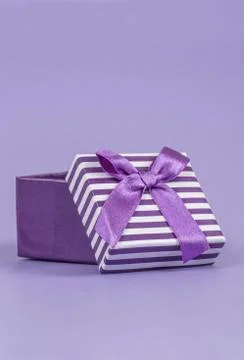 Opened gift box on purple Stock Photos