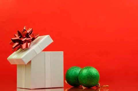 Opened gift in red background Stock Photos