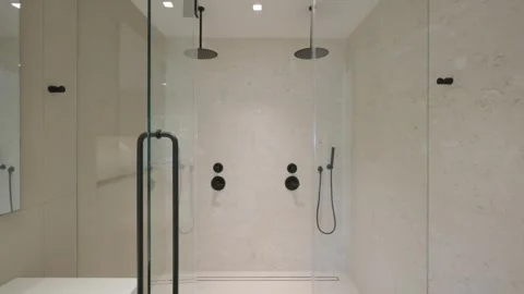 Opened glassy door showing content of shower cabinet in hotel bathroom with Stock Footage 280419273